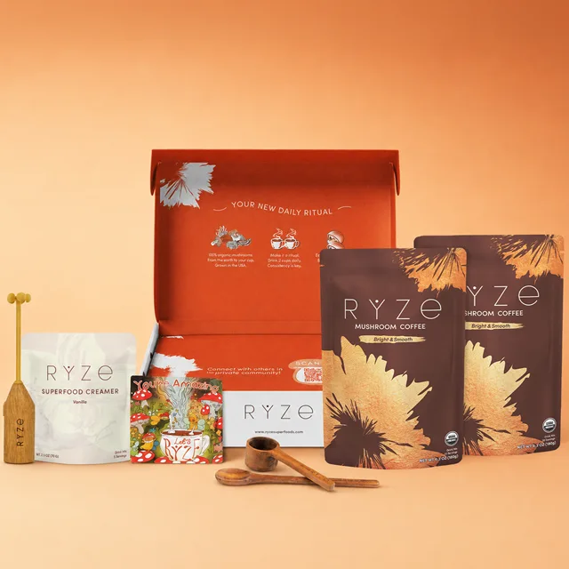 The RYZE Starter Kit — two bags of mushroom coffee, vanilla creamer, frother, wooden spoon and scoop in an open gift box