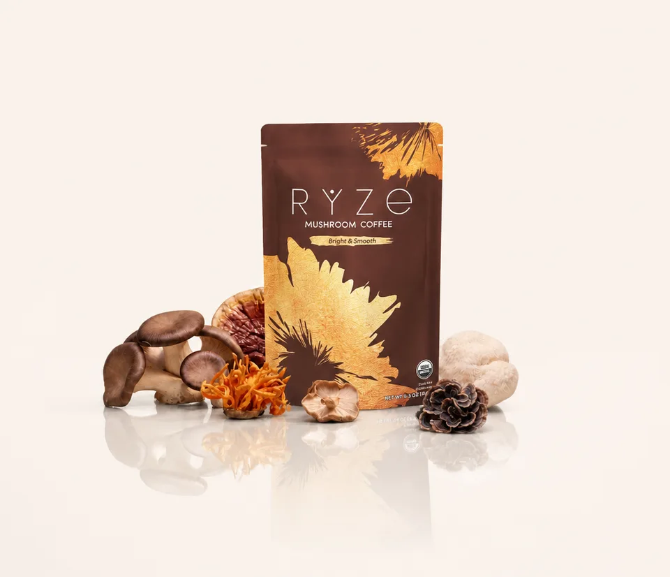 The RYZE Mushroom Coffee pouch surrounded by the six whole functional mushrooms in the blend