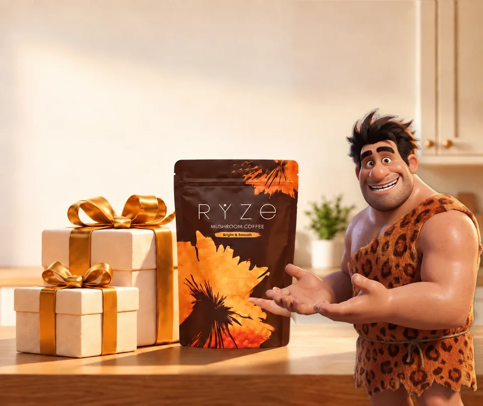 UP TO 40% OFF + FREE GIFTS. RYZE coffee and two wrapped gifts on a kitchen counter with the animated caveman presenting them in the foreground.