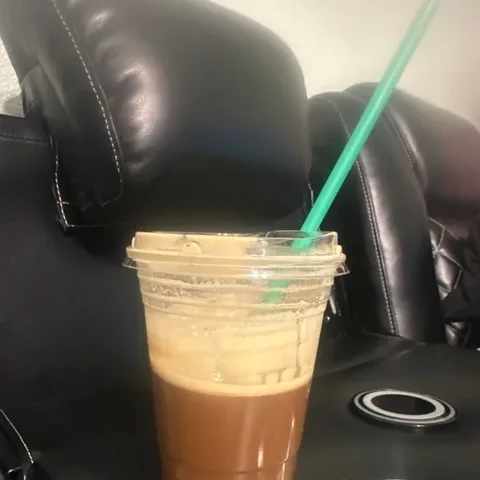 Real RYZE customer photo: relaxing on a sofa with an iced RYZE.