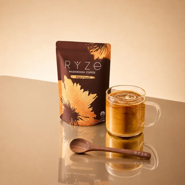 A prepared cup of RYZE mushroom coffee held in both hands