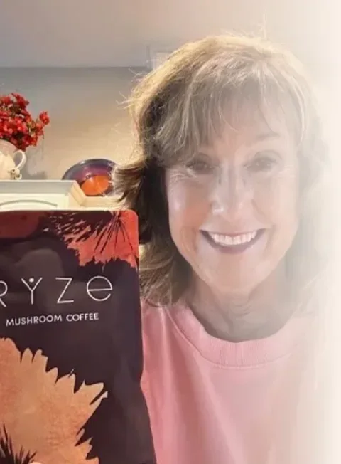 Brenda holding a mug of RYZE