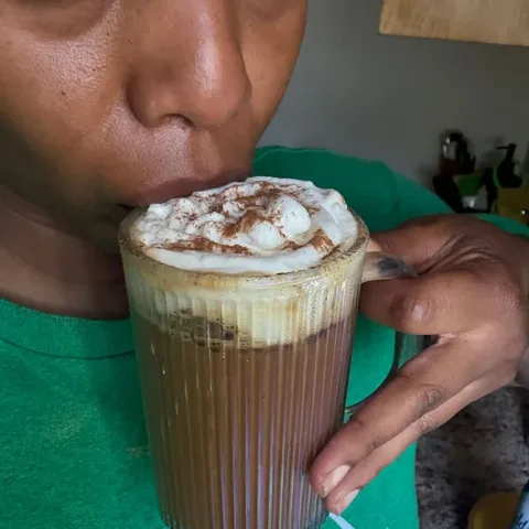 Customer taking a sip of a whipped RYZE latte