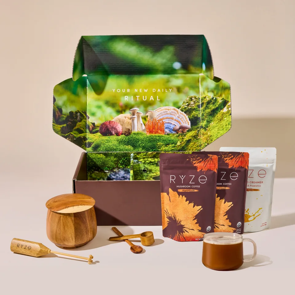 The RYZE ritual set - gift box, mushroom coffee and creamer pouches, wooden scoop, canister and a mug of brewed coffee